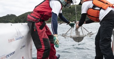 Researchers pull out a "Smith-McIntyre" grab machine collecting sediment samples during a joint project of the French Tara Ocean Foundation and Japanese marine-station network Jambio, on board a boat off the coast of Shimoda, Shizuoka Prefecture, Japan, Oct. 14, 2021. (AFP Photo)