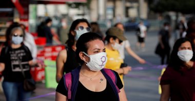 Women maintain social distancing while holding purple ribbons as they protest for women's rights, Istanbul, Turkey, May 20, 2020. (Reuters Photo)