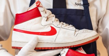 A Sotheby's employee holds the pair of Michael Jordan's Nike Air Ships from 1984 that sold for $1.47 million at auction. (Julian Cassady Photography/via Sotheby's)