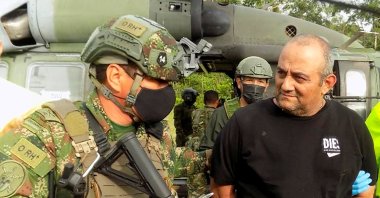 Dairo Antonio Usuga David, known as "Otoniel", is escorted by Colombian military personnel after being captured, in Turbo, Colombia, Oct. 23, 2021. (Colombian Defense Ministry via Reuters)