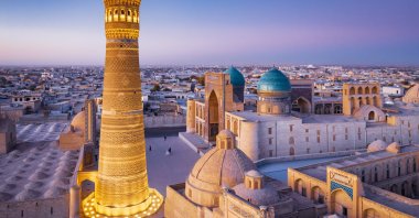 A colorful sunset backdrops the famous Old Town in the City of Bukhara with the iconic Kalyan Minaret and Mir-i Arab Madrasa, Uzbekistan. (Photo by Getty Images)