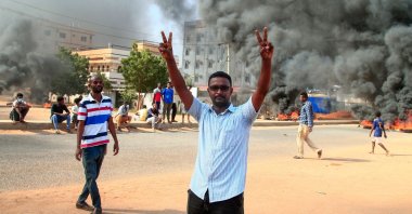 A Sudanese demonstrator flashes the victory sign during a demonstration in the capital Khartoum, on Oct. 25, 2021, to denounce overnight detentions by the army of members of Sudan's government. (AFP Photo)