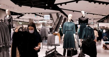A woman looks at clothes at a Polish fashion retailer LPP branded Reserved shop, amid the coronavirus pandemic, Warsaw, Poland, Sept. 4, 2020. (Reuters Photo)