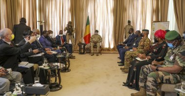 Malian Transition President Col. Assimi Goita, center, holds a meeting with a United Nations Security Council mission led by Kenya's Ambassador to the U.N. Martin Kimani in Bamako, Mali, Oct. 24, 2021. (AP Photo)