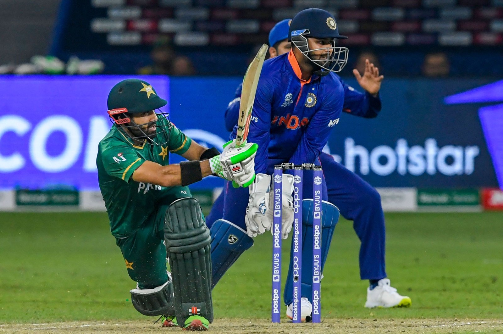 Pakistan's Mohammad Rizwan (L) plays a shot during the ICC men's Twenty20 World Cup match against India at the Dubai International Cricket Stadium in Dubai, United Arab Emirates, Oct. 24, 2021. (AFP Photo)