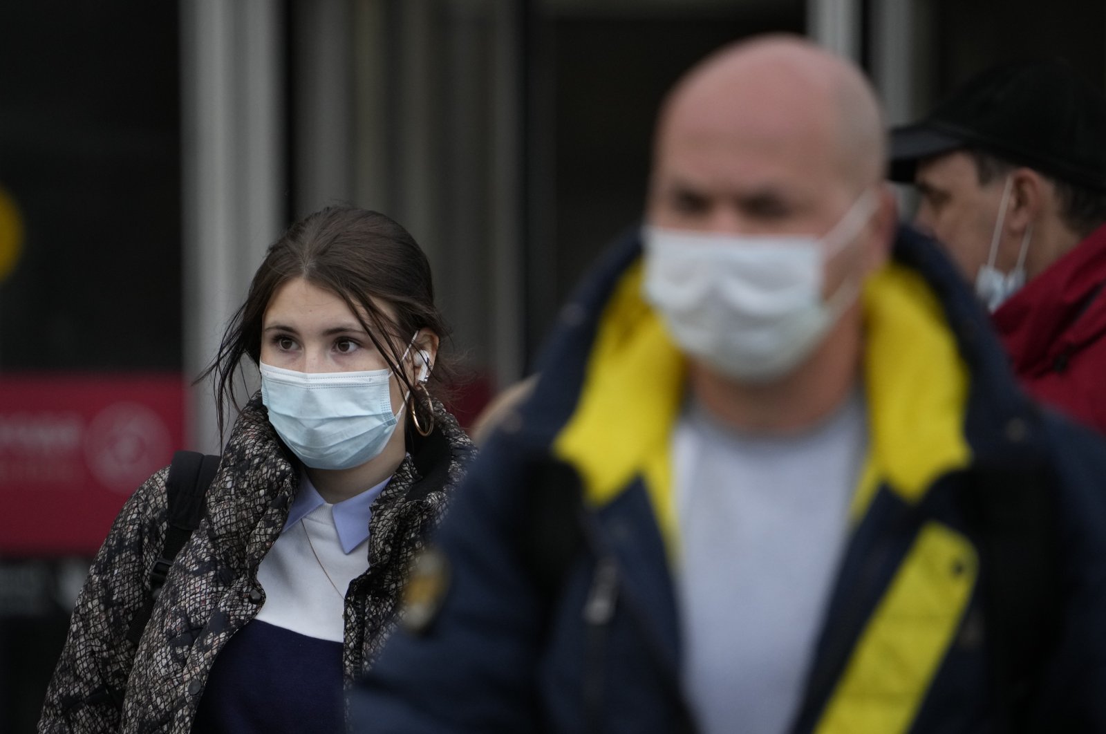 People wearing face masks to help curb the spread of the coronavirus leave a subway in Moscow, Russia, Oct. 15, 2021. (AP Photo)