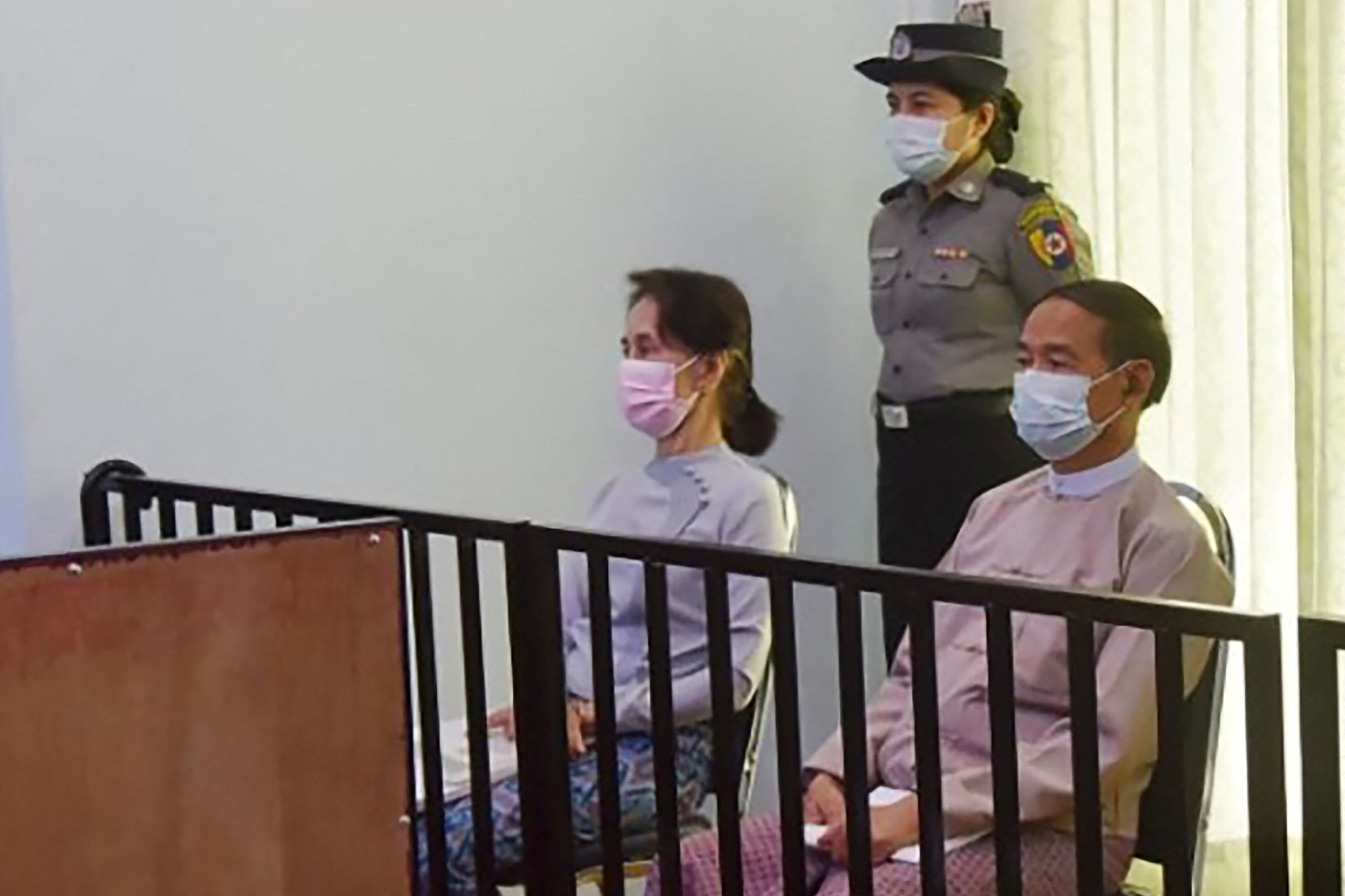 This file handout photo shows detained civilian leader Aung San Suu Kyi (L) and detained President Win Myint (R) during their first court appearance, since the military detained them in a coup on Feb. 1, in Naypyidaw, Myanmar, May 24, 2021. (Myanmar's ministry of information via AFP)