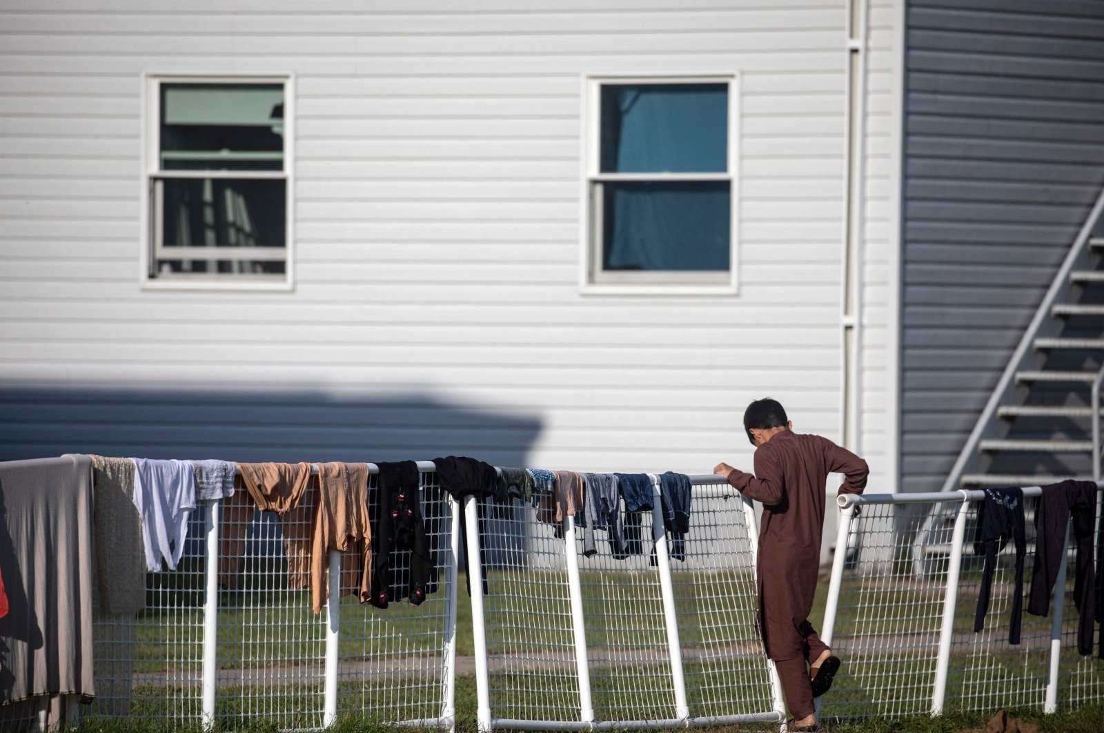 An Afghan refugee stands outside temporary housing at Ft. McCoy U.S. Army base, Sept. 30, 2021, Wisconsin, U.S. (AFP Photo)
