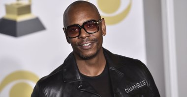 Dave Chappelle poses in the press room with the best comedy album award for "The Age of Spin" and "Deep in the Heart of Texas" at the 60th annual Grammy Awards in New York, U.S., Jan. 28, 2018. (AP Photo)