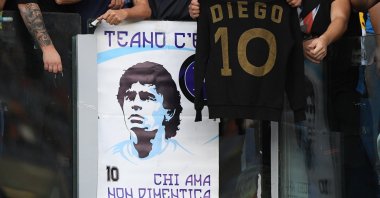 Napoli fans display a banner and shirt in honor of former player Diego Maradona before a Serie A match against AS Roma at Stadio Olimpico, Rome, Italy, Oct. 24, 2021. (Reuters Photo)