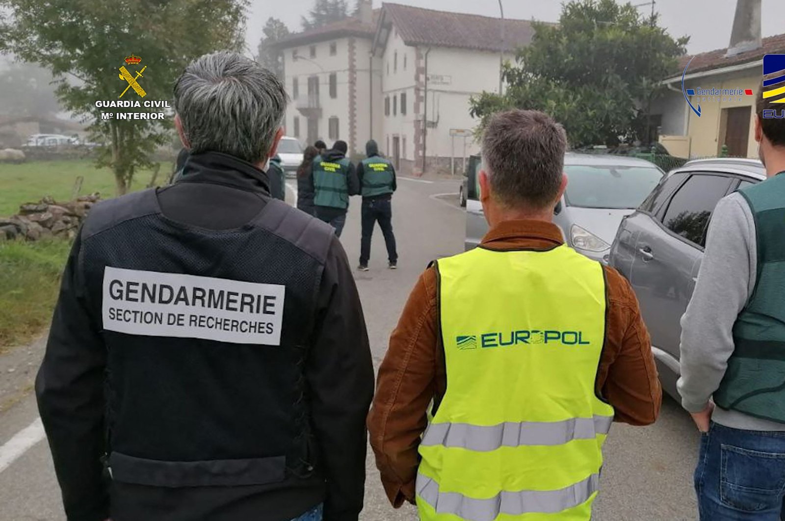 This handout picture released by the Spanish Guardia Civil on October 25, 2021 shows (L to R) members of French Gendarmerie, Europol and Guardia Civil taking part in a joint operation against smugglers transferring irregular migrants to France, in Urrasun and Irurita in Navarre region, northern Spain. (AFP Photo)