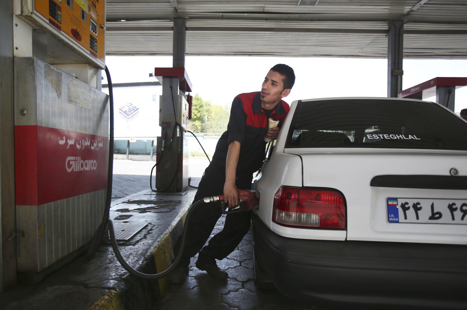 A gas station worker fills a car in central Tehran, Iran, Friday, April 25, 2014. (AP Photo)