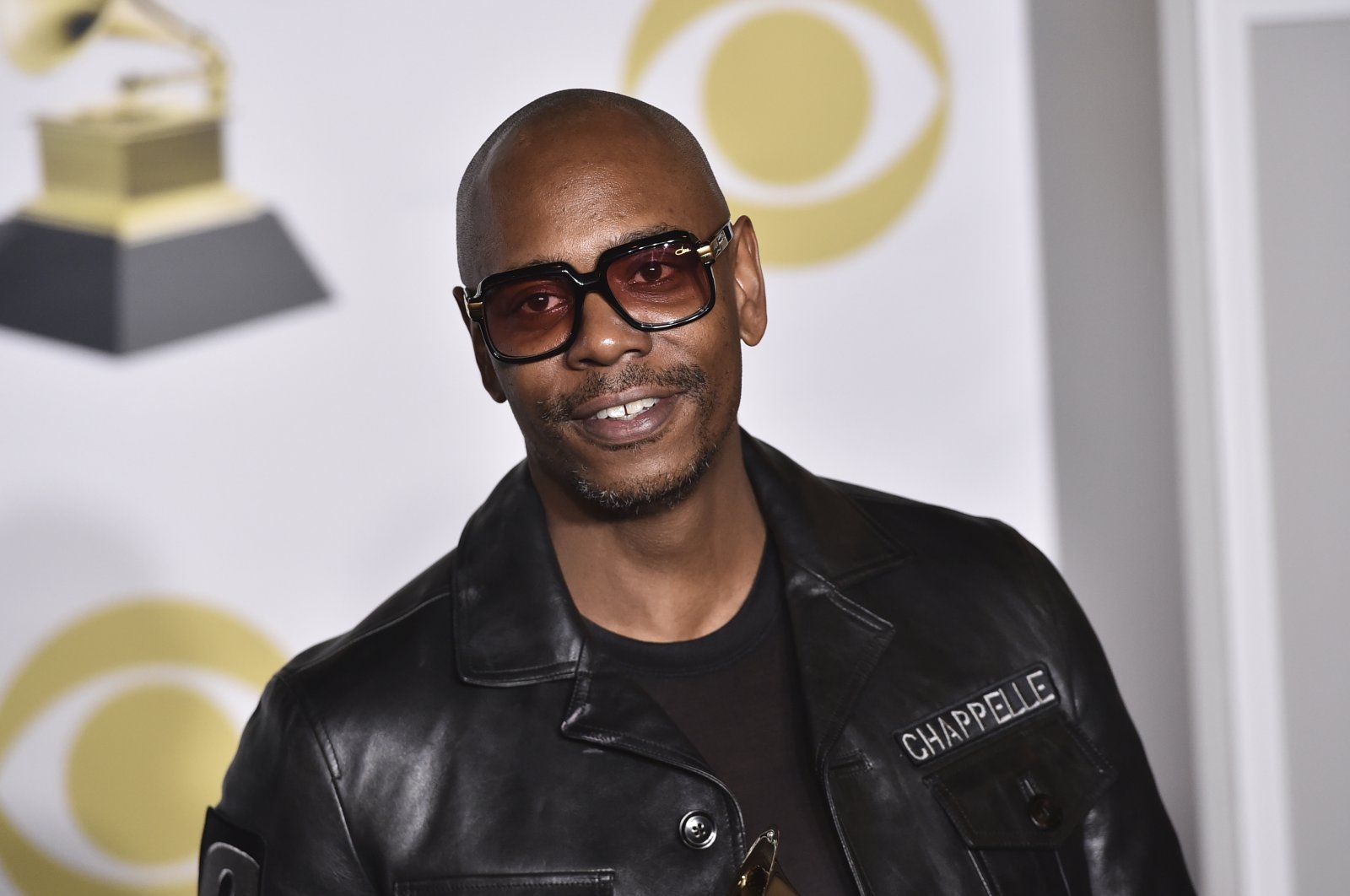 Dave Chappelle poses in the press room with the best comedy album award for "The Age of Spin" and "Deep in the Heart of Texas" at the 60th annual Grammy Awards in New York, U.S., Jan. 28, 2018. (AP Photo)