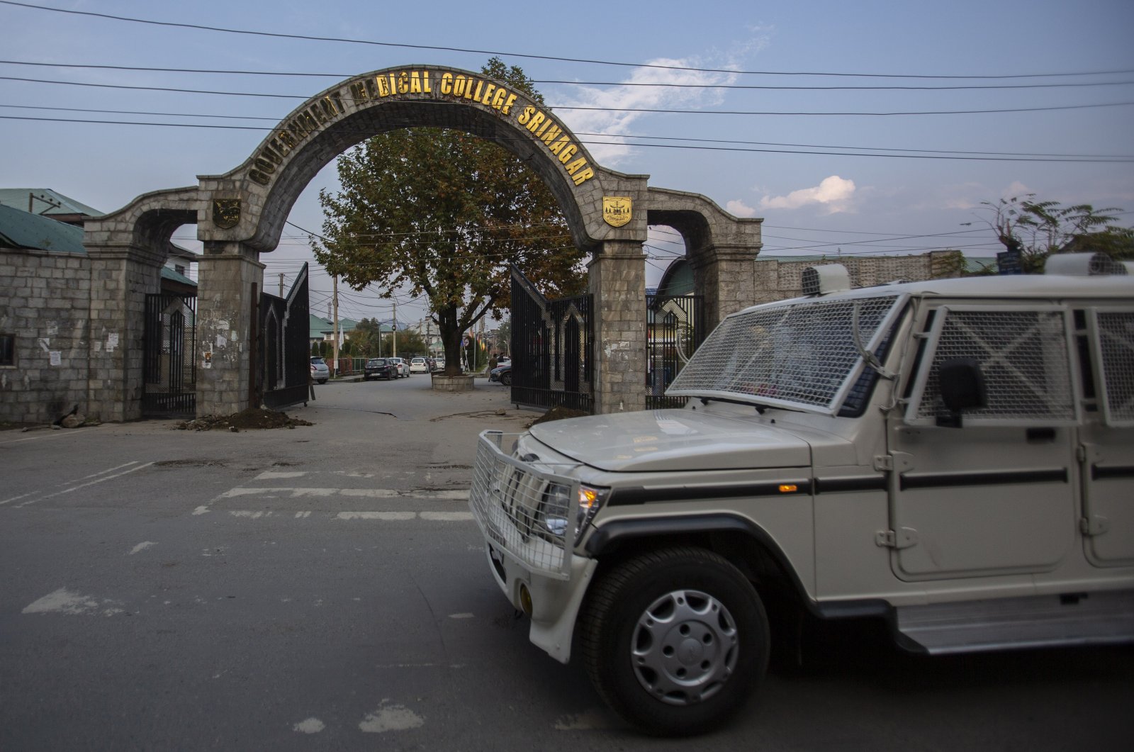 A paramilitary vehicle passes the front gate of Government Medical College in Srinagar, Indian controlled Kashmir, Oct. 26, 2021. (AP Photo)
