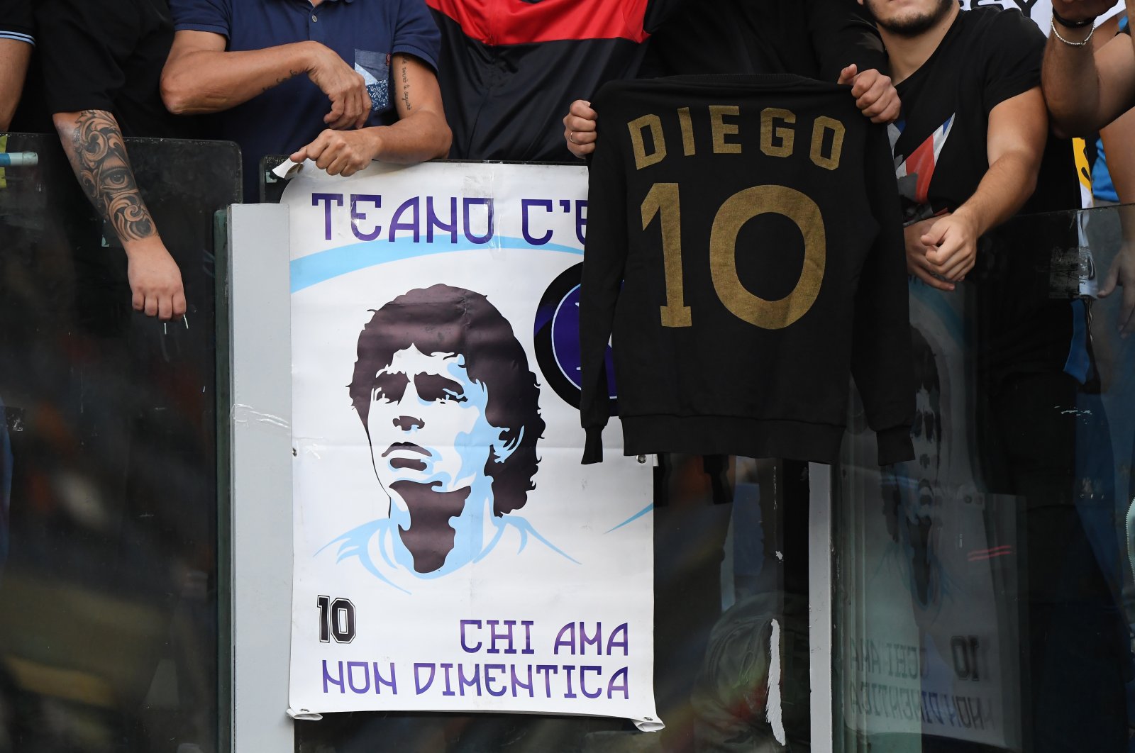 Napoli fans display a banner and shirt in honor of former player Diego Maradona before a Serie A match against AS Roma at Stadio Olimpico, Rome, Italy, Oct. 24, 2021. (Reuters Photo)