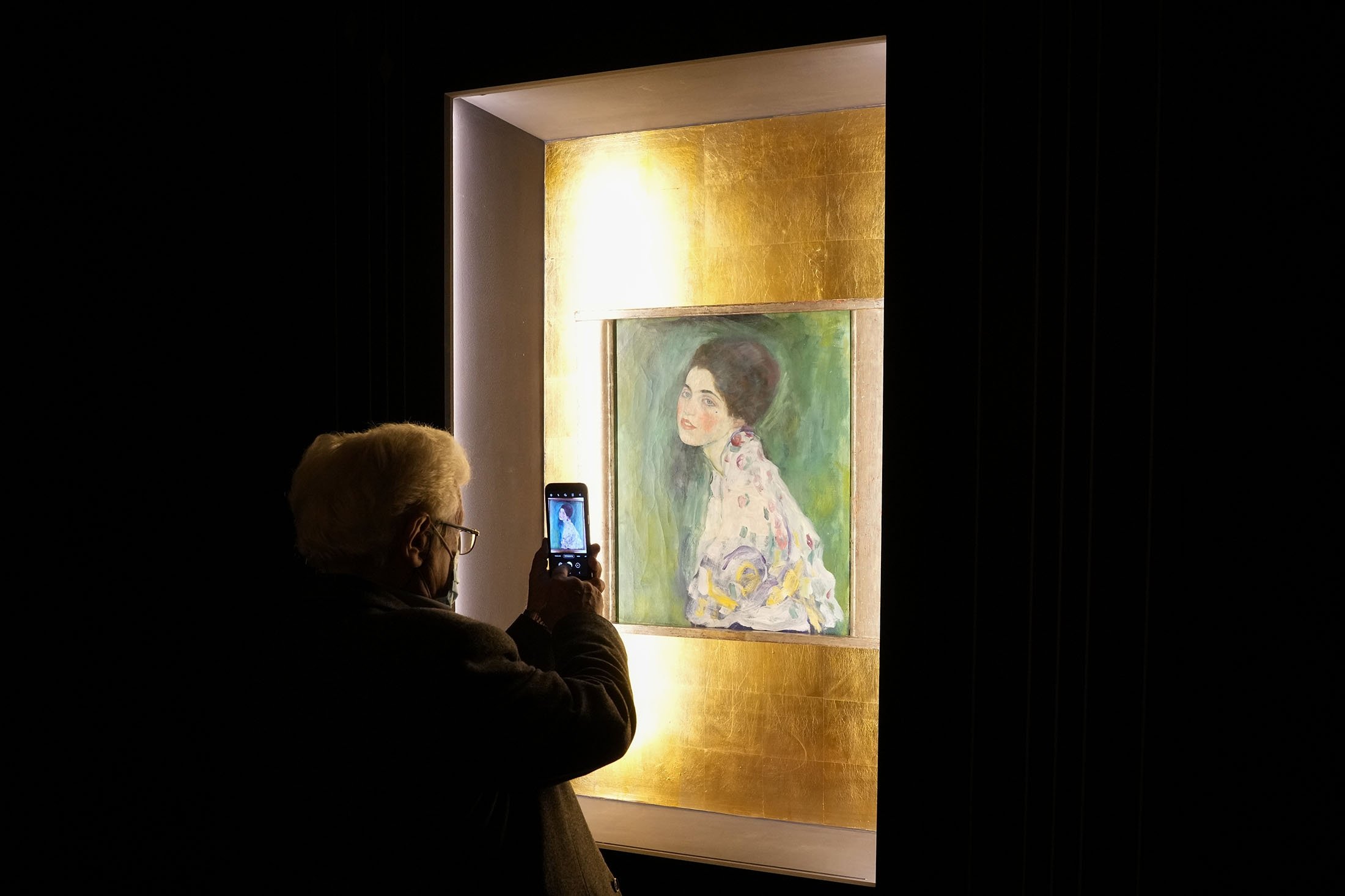 A woman takes a photo of Gustav Klimt