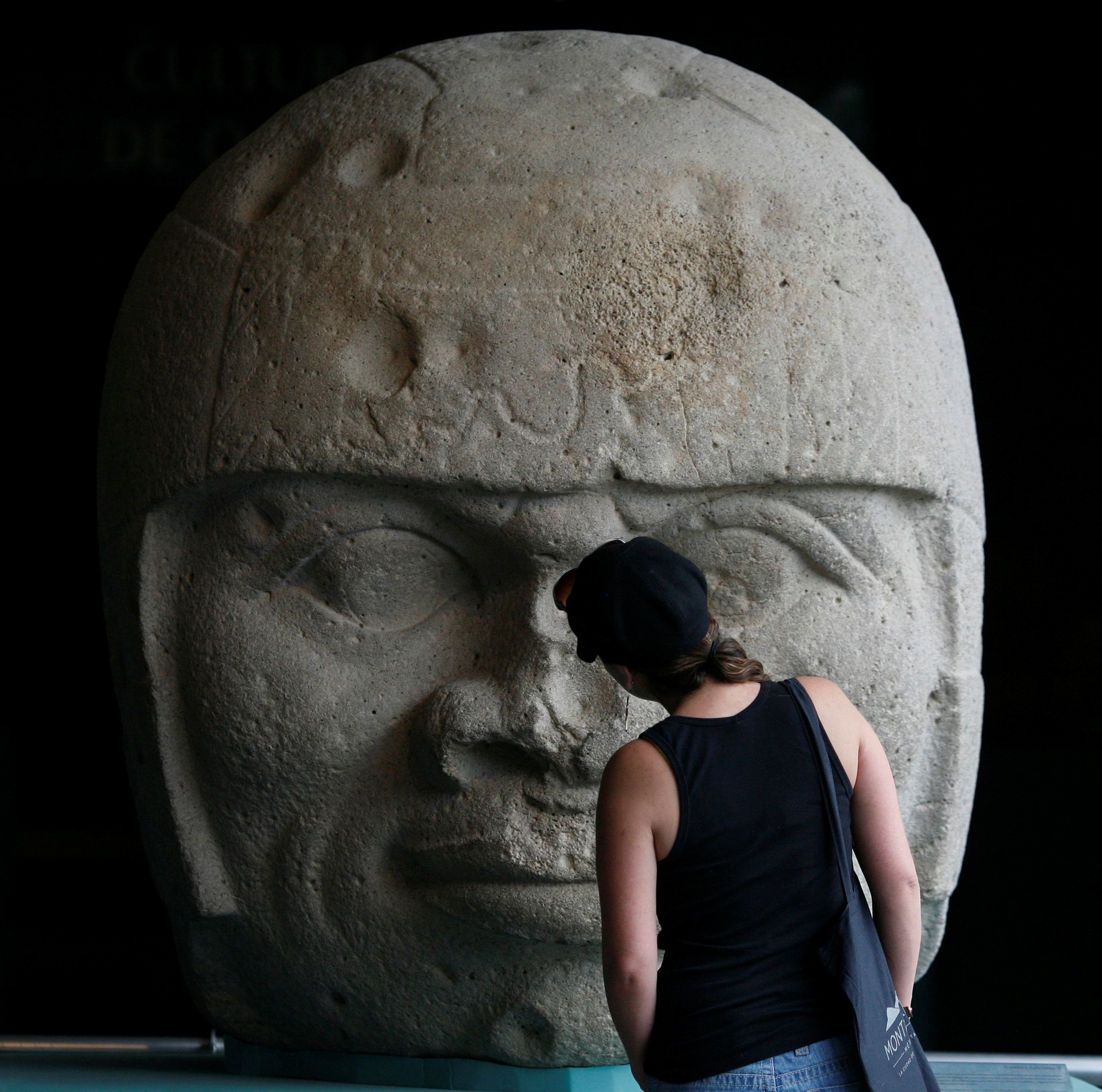 A visitor looks at an Olmec colossal head during the preview of 'Colossal masterworks of the Olmec world' exhibition at the Anthropology Museum in Mexico City, Mexico, July 20, 2011. (Reuters Photo)