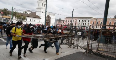 Protesters remove a crowd control barricade near the government palace on the first day of a general, nation-wide strike to decry the rise in gas prices and the policies of Ecuador's President Guillermo Lasso, in Quito, Ecuador, Oct. 26, 2021. (AP Photo)