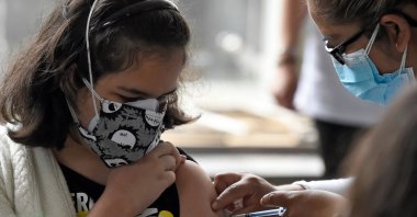 A minor is inoculated with their first dose of the Pfizer-BioNtech COVID-19 vaccine at the Vasconcelos Library in Mexico City, Mexico, Oct. 25, 2021. (AFP Photo)