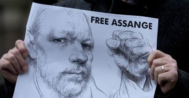 A demonstrator holds a poster as supporters of Julian Assange stage a demonstration outside the High Court in London, Britain, Oct. 27, 2021. (AP Photo)