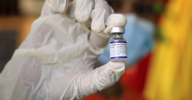 A healthcare worker shows a vial of Pfizer COVID-19 vaccine during a vaccination drive for children over twelve years of age in Dili, East Timor, also known as Timor Leste, 27 Oct. 2021. (EPA Photo) 