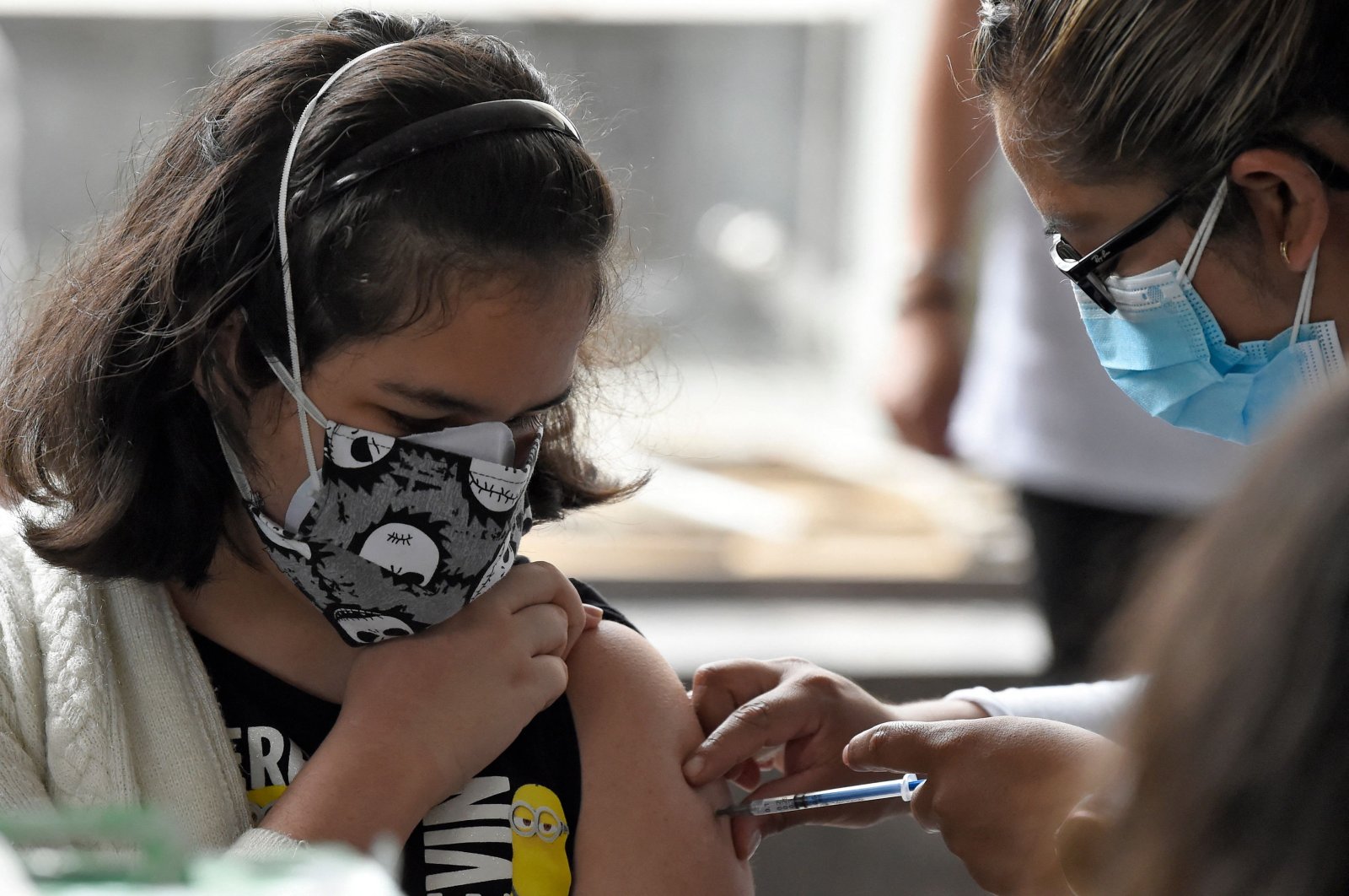 A minor is inoculated with their first dose of the Pfizer-BioNtech COVID-19 vaccine at the Vasconcelos Library in Mexico City, Mexico, Oct. 25, 2021. (AFP Photo)