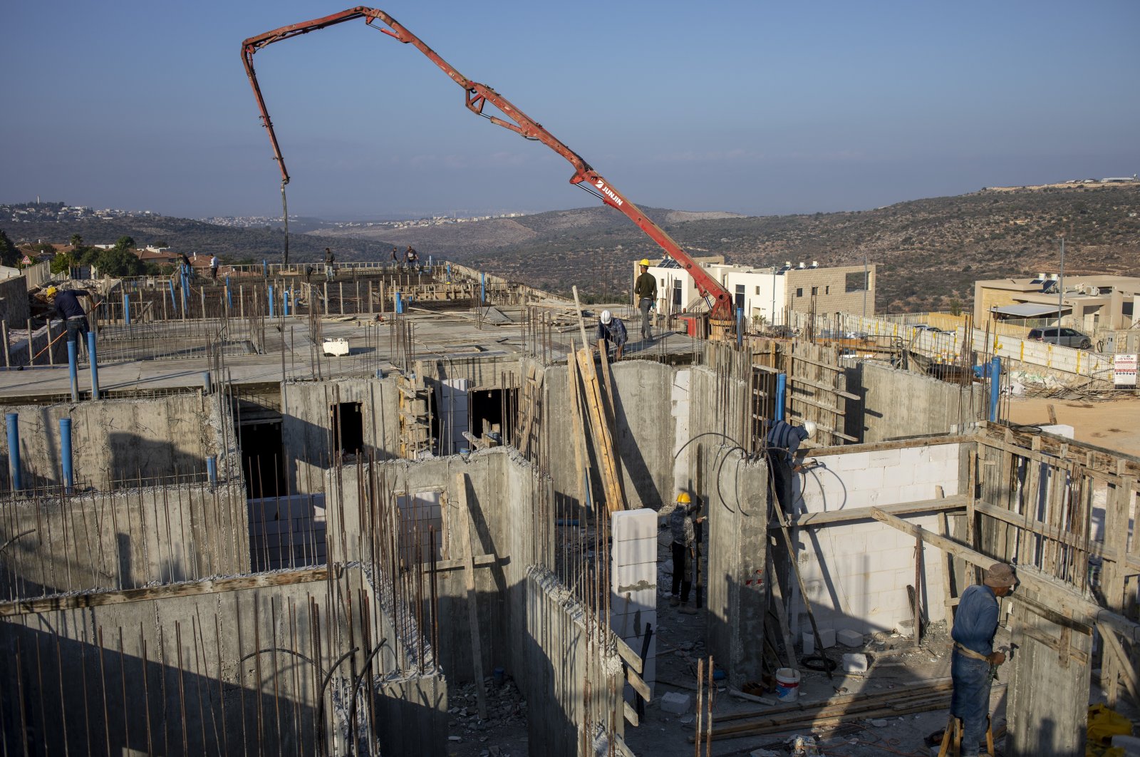 Palestinians built new houses in the West Bank Jewish settlement of Bruchin near the Palestinian town of Nablus, Monday, Oct. 25, 2021. (AP Photo)