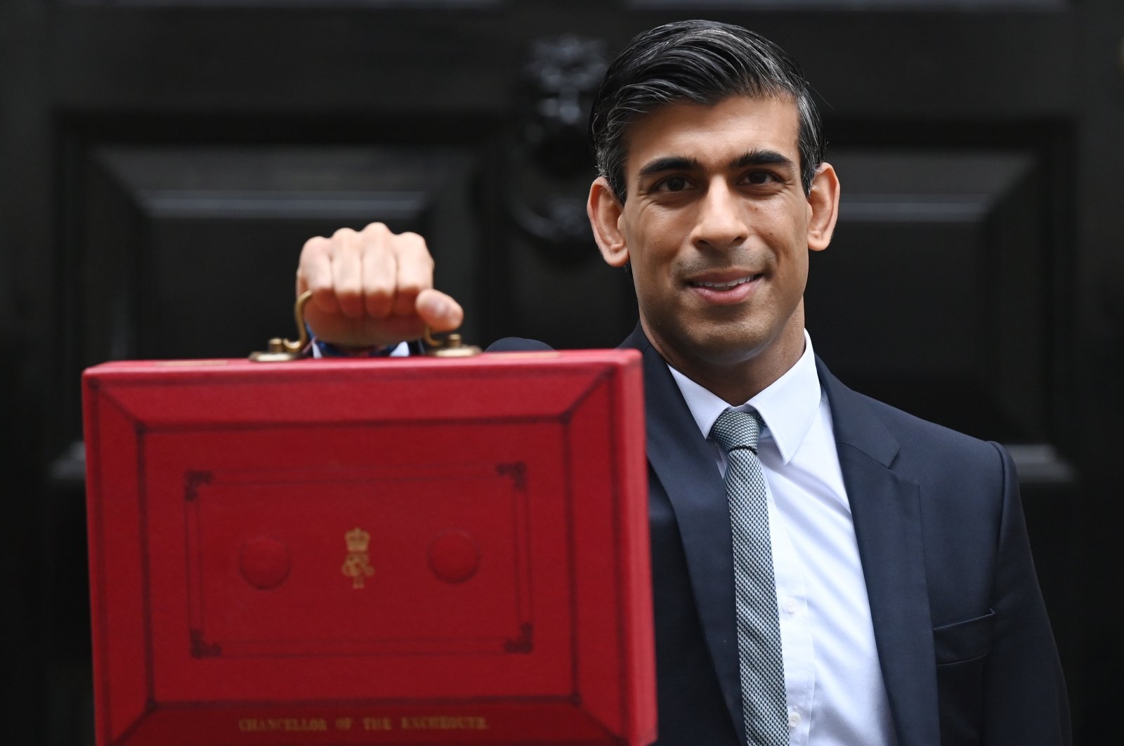 Britain's Chancellor of the Exchequer Rishi Sunak poses for photographers with the Budget box as he leaves 11 Downing Street in London, Britain, Oct. 27, 2021. (EPA Photo)