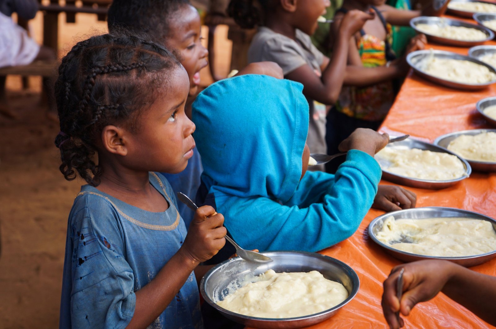 Malagasy children eat a meal at the Avotse feeding program that benefits malnourished children with hot meals in Maropia Nord village in the region of Anosy, southern Madagascar, Sept. 30, 2021. (Reuters Photo)