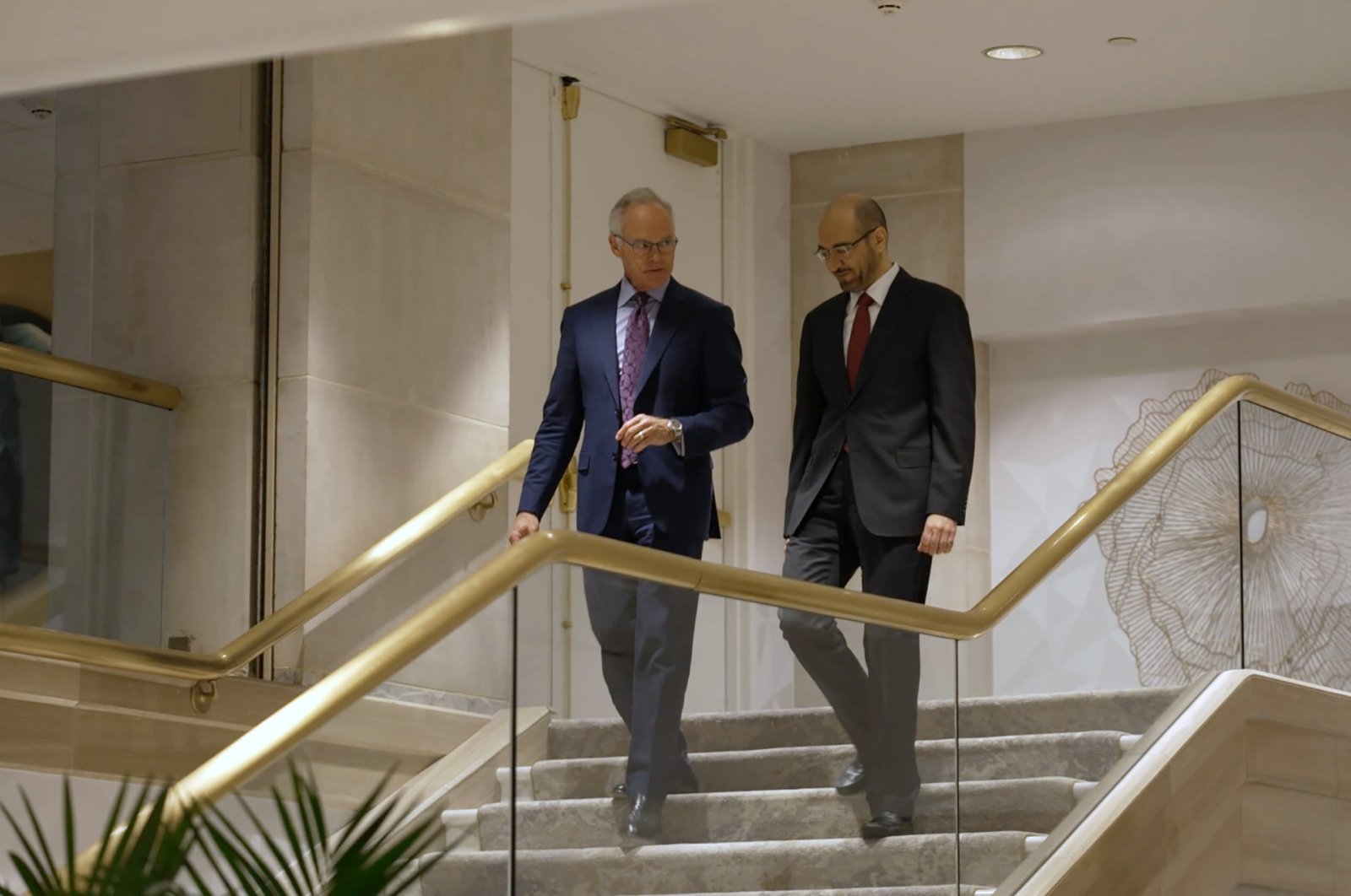 In this summer 2021 photo provided by CBS News, former senior Saudi security official Saad al-Jabri (R) walks with journalist Scott Pelley in Washington during an interview for "60 Minutes." (CBS News/60 Minutes via AP)