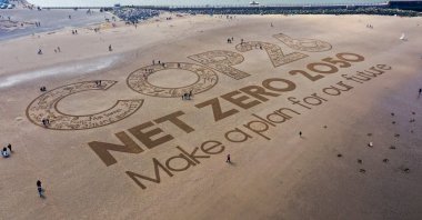 A giant sand artwork adorns New Brighton Beach to highlight global warming and the forthcoming COP26 global climate conference, Wirral, Merseyside, the U.K., May 31, 2021. (Photo by Getty Images)