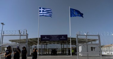 A Greek national flag and a European Union flag flutter inside a newly inaugurated compound-type migrant camp on the island of Samos, Greece, Sept. 18, 2021.  (REUTERS Photo)