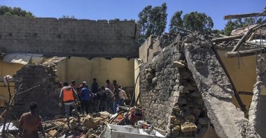 Residents sift through rubble from a destroyed building at the scene of an airstrike in Mekele, in the Tigray region of northern Ethiopia, Oct. 28, 2021. (AP Photo)