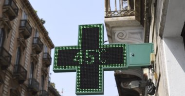A pharmacy thermometer reports the temperature as 45 degrees Celsius in a street of Catania, Sicily, southern Italy, Aug. 11, 2021. (AP Photo)