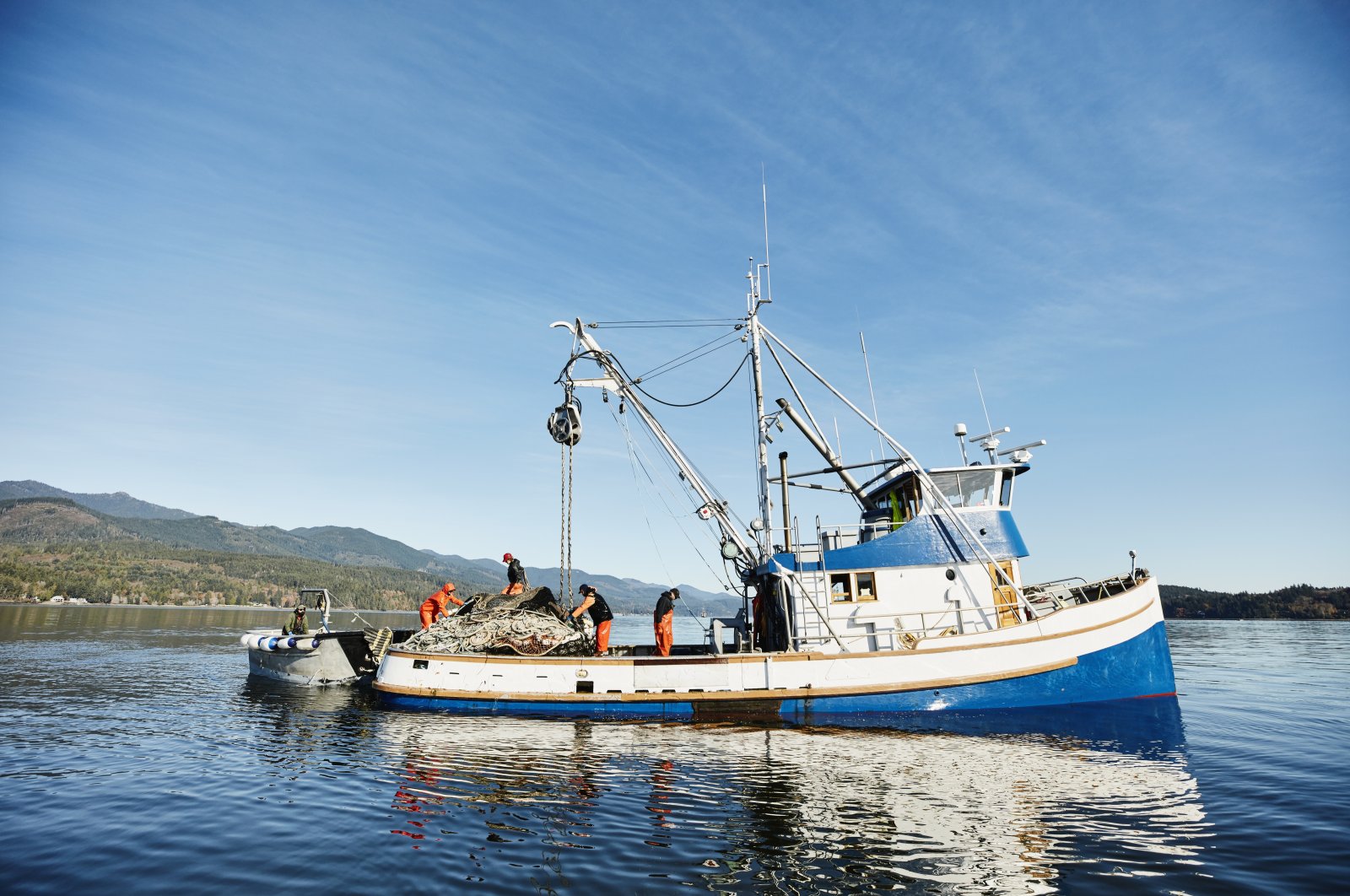Crew on purse seiner organizing gear while fishing for salmon on fall morning. (Getty Images)