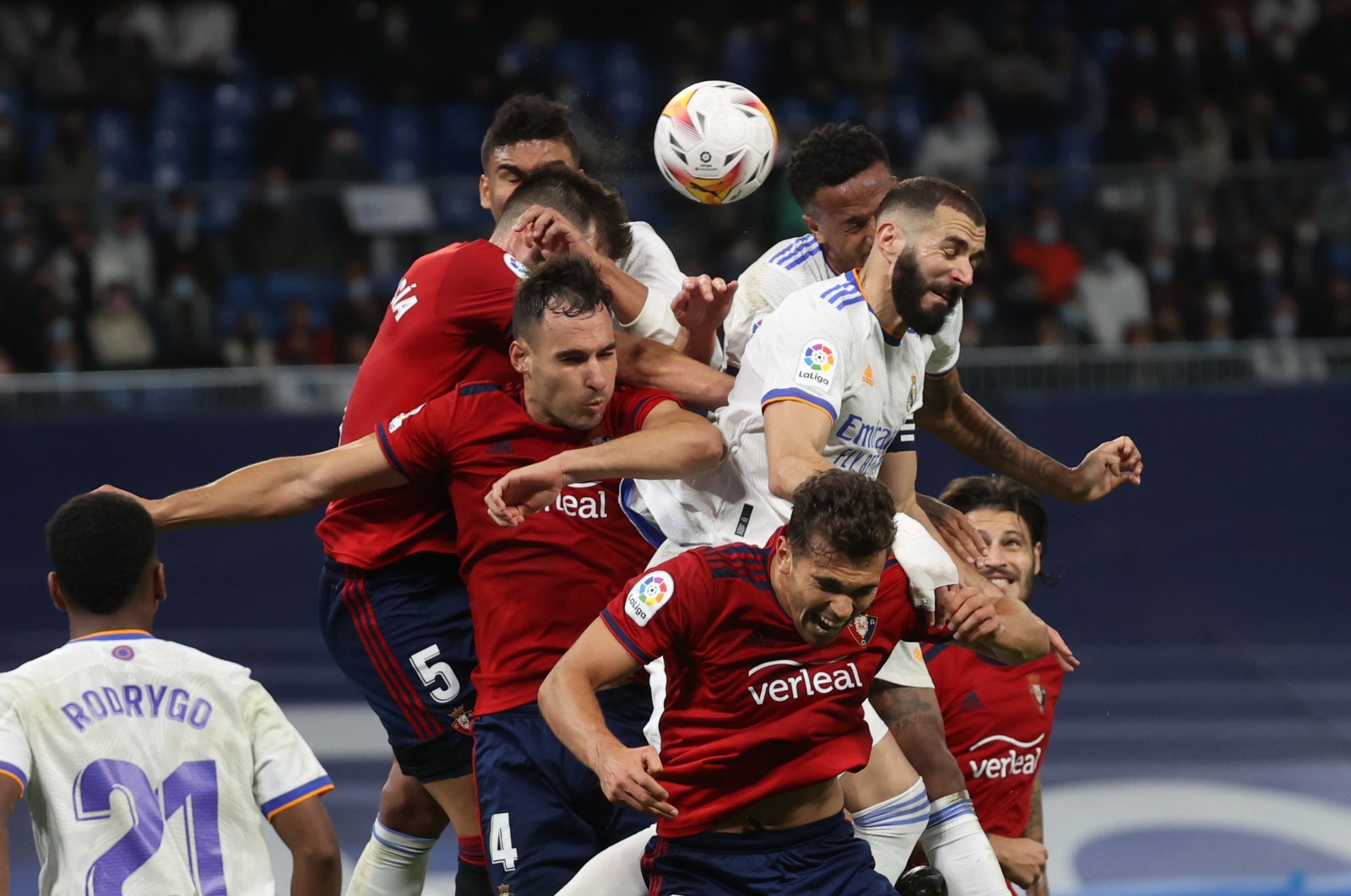 Real Madrid striker Karim Benzema (R) jumps for the ball with some Osasuna players during a La Liga match at Santiago Bernabeu, Madrid, Spain, Oct. 27, 2021. (EPA Photo)