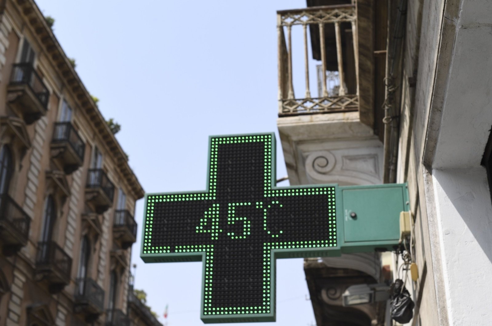 A pharmacy thermometer reports the temperature as 45 degrees Celsius in a street of Catania, Sicily, southern Italy, Aug. 11, 2021. (AP Photo)