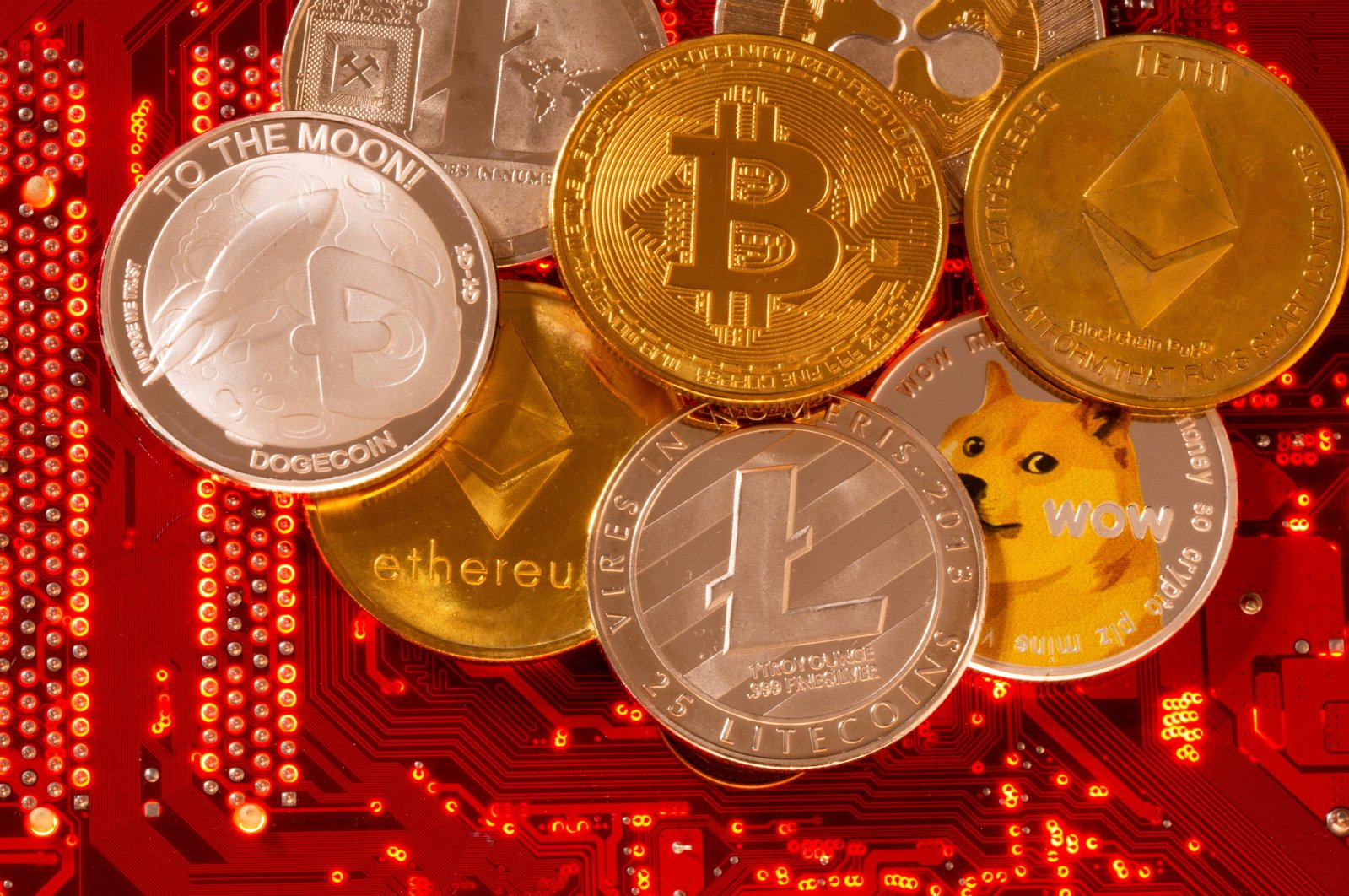 Representations of cryptocurrencies Bitcoin, Ethereum, DogeCoin, Ripple, Litecoin are placed on a PC motherboard in this illustration taken, June 29, 2021. (Reuters File Photo)