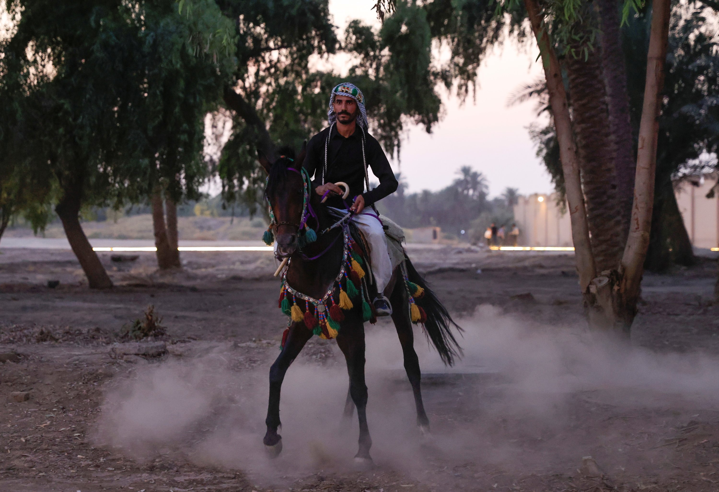 A local actor rides a horse during the opening ceremony of the Babylon International Festival in the ancient city of Babylon, Iraq, Oct. 28, 2021. (REUTERS)