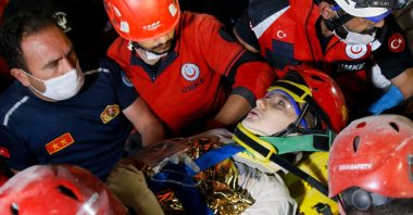 Rescuers pull Günay Özışık from the rubble, in Izmir, western Turkey, Oct. 31, 2020. (AA PHOTO) 