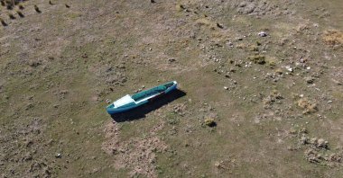 A boat sits on a dried part of Lake Beyşehir which suffers from severe drought amid climate change, in Konya, central Turkey, Oct. 26, 2021. (AA PHOTO) 
