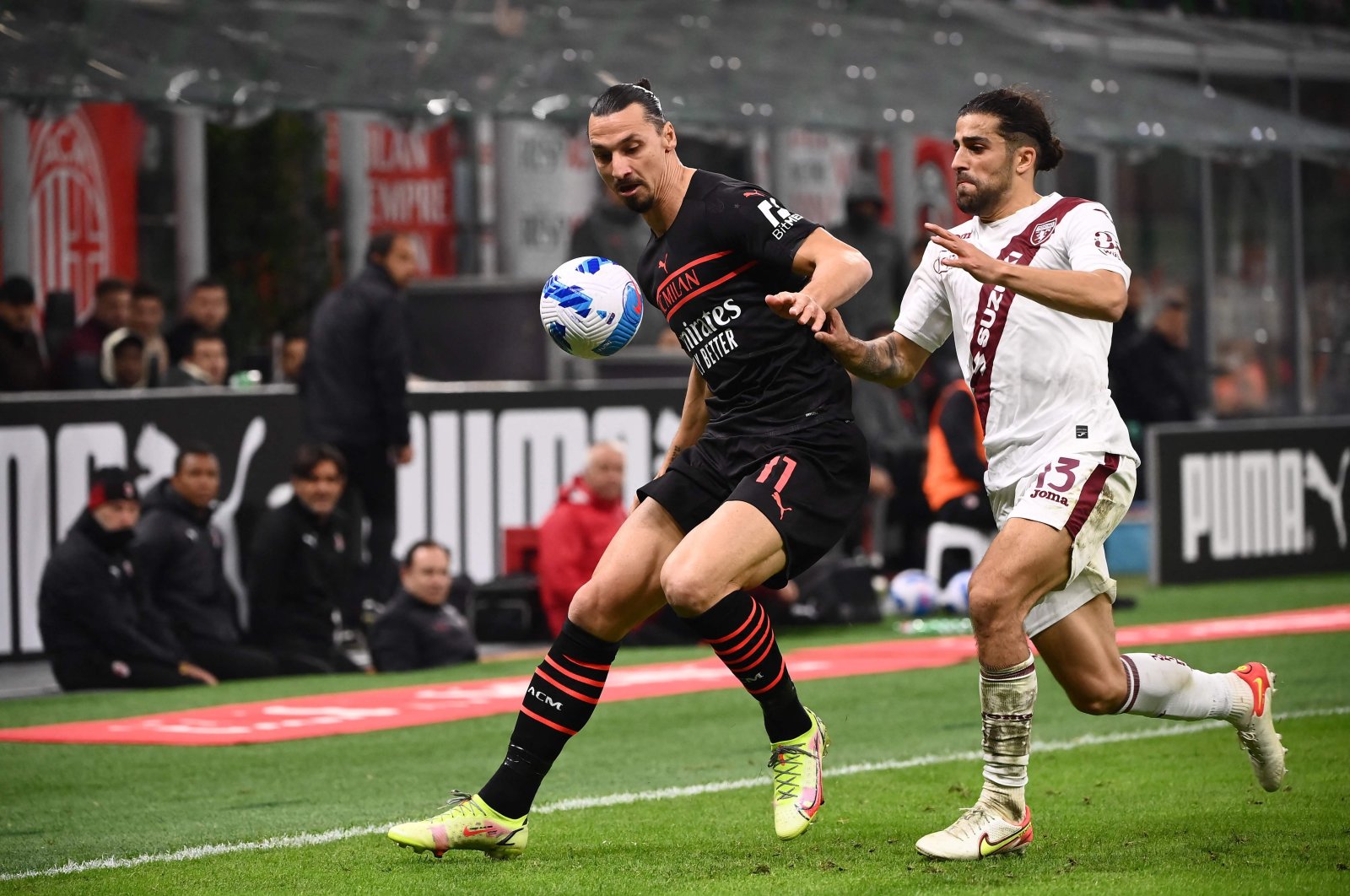 AC Milan's Zlatan Ibrahimovic (L) fights for the ball with Torino's Ricardo Rodriguez (R) during a Serie A match at the San Siro in Milan, Italy, Oct. 26, 2021. (AFP Photo)