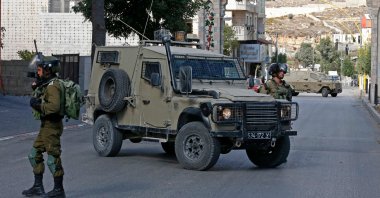 Israeli soldiers block a street following a demonstration calling for the release of Palestinian prisoners on hunger strike in Israeli jails, in the West Bank city of Hebron, occupied Palestine, Oct. 24, 2021. (AFP Photo)