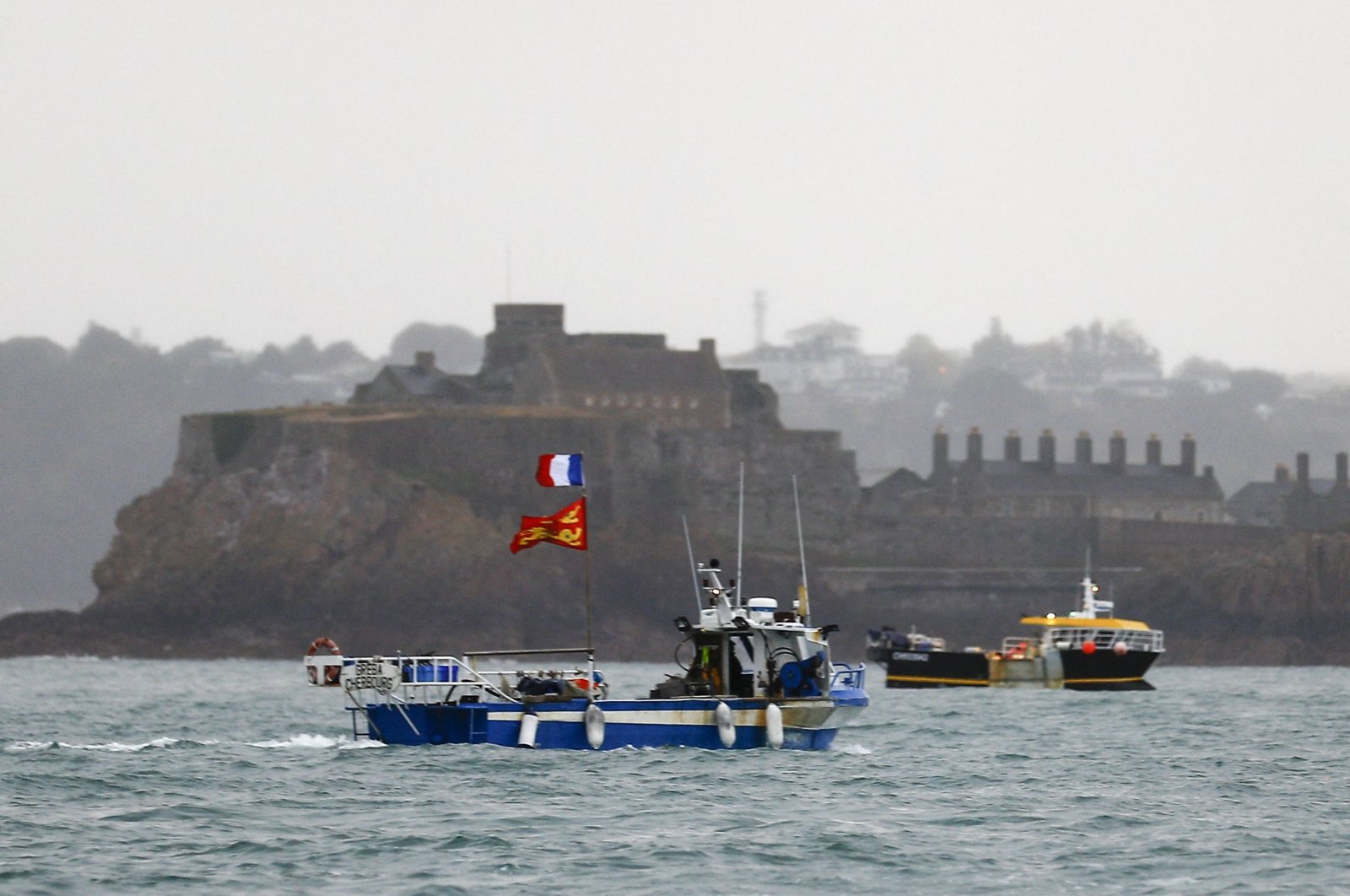 French fishing boats protest in front of the port of Saint Helier off the British island of Jersey to draw attention to what they see as unfair restrictions on their ability to fish in UK waters after Brexit, Jersey, United Kingdom, May 6, 2021. (AFP Photo)