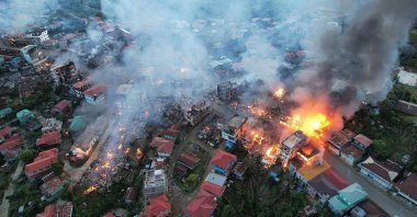 In this photo, fires can be seen in the town of Thantlang in Myanmar's northwestern state of Chin, on Friday, Oct. 29, 2021. (Photo by AP)