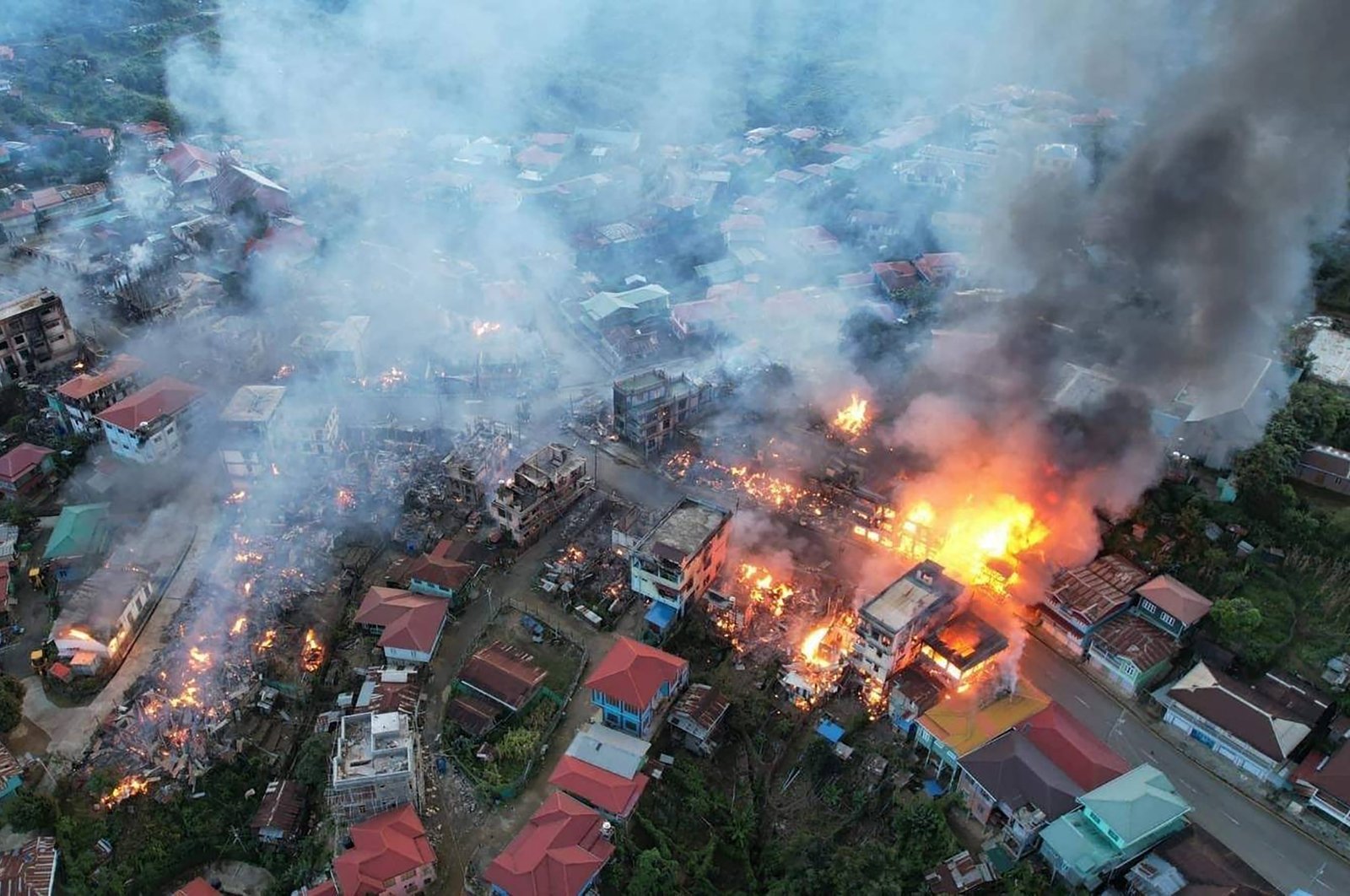 In this photo, fires can be seen in the town of Thantlang in Myanmar's northwestern state of Chin, on Friday, Oct. 29, 2021. (Photo by AP)