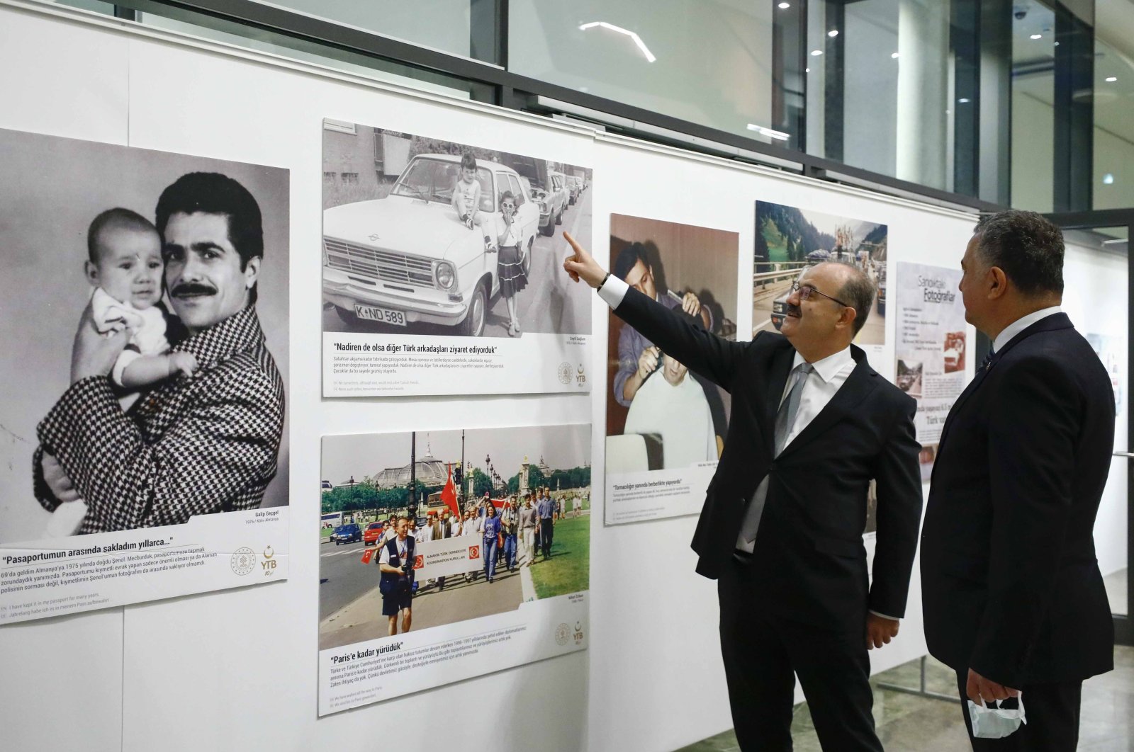 ​​​​​​​​​​​Deputy Culture and Tourism Minister Serdar Çam (L) and Turkey's ambassador to Berlin, Ahmet Başar Şen, visit an exhibition during the "60th Anniversary of the German Turkish Diaspora" event in Berlin, Germany, Oct. 31, 2021. (AA Photo)