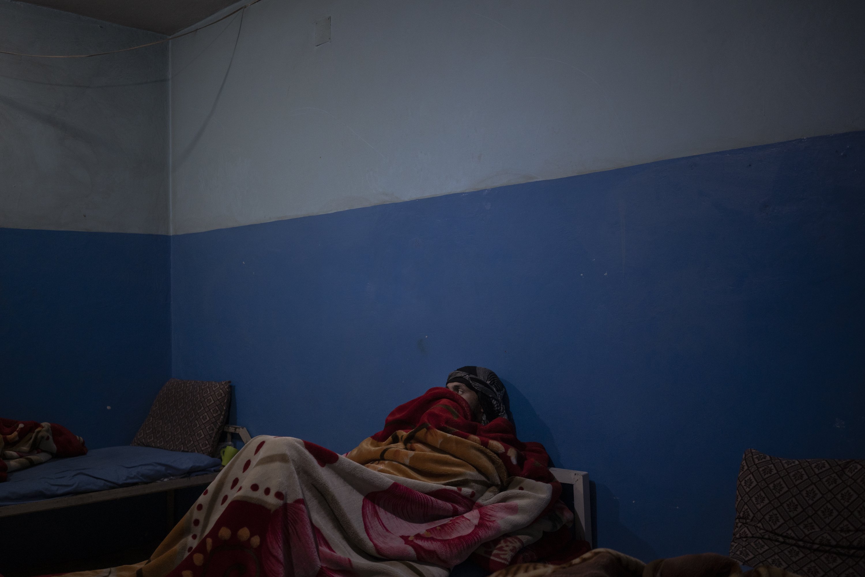 A patient who is being treated for his drug addiction lies in his hospital bed in Mirbacha Kot, Afghanistan, Oct. 24, 2021. (AP Photo)