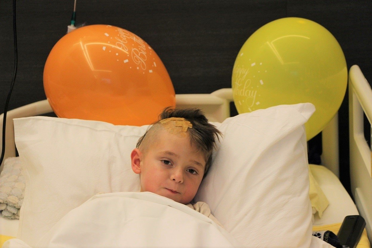Eduard Costan, a 4-year-old from Romania, can be seen in bed after undergoing surgery in Turkey. (Photo by DHA)