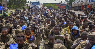 Captured Ethiopian government soldiers and allied militia members sit in rows after being paraded by Tigray forces through the streets in open-top trucks, as they arrived to be taken to a detention center in Mekele, the capital of the Tigray region of northern Ethiopia, Oct. 22, 2021. (AP Photo)